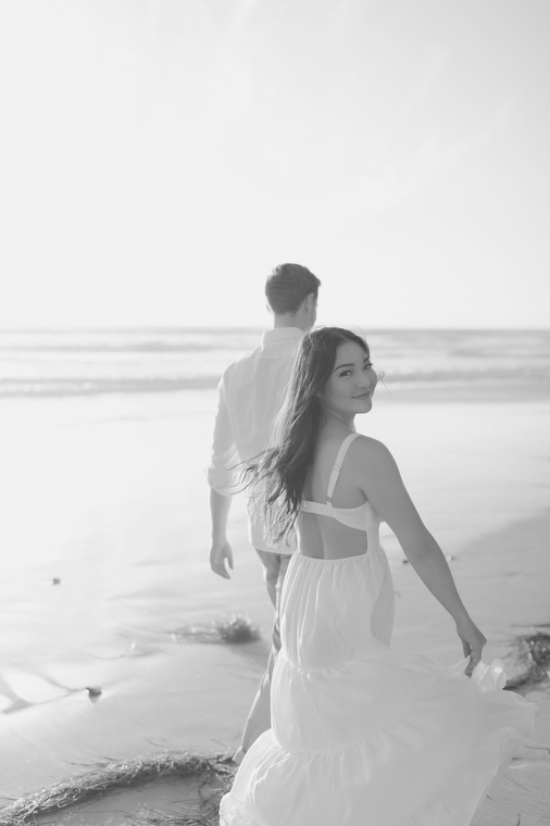 black and white photo of a couple on the beach