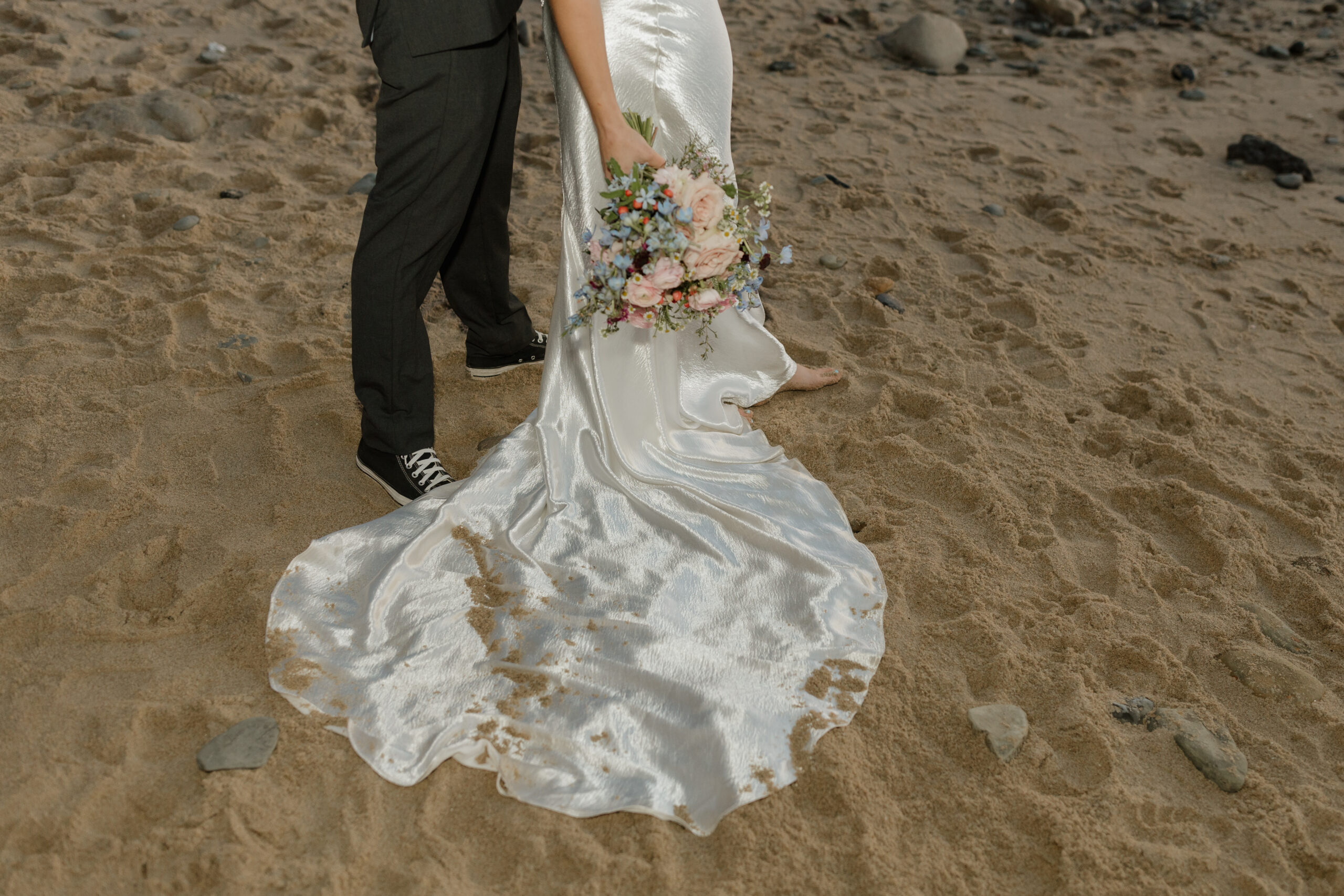 Brides dress with sand on it