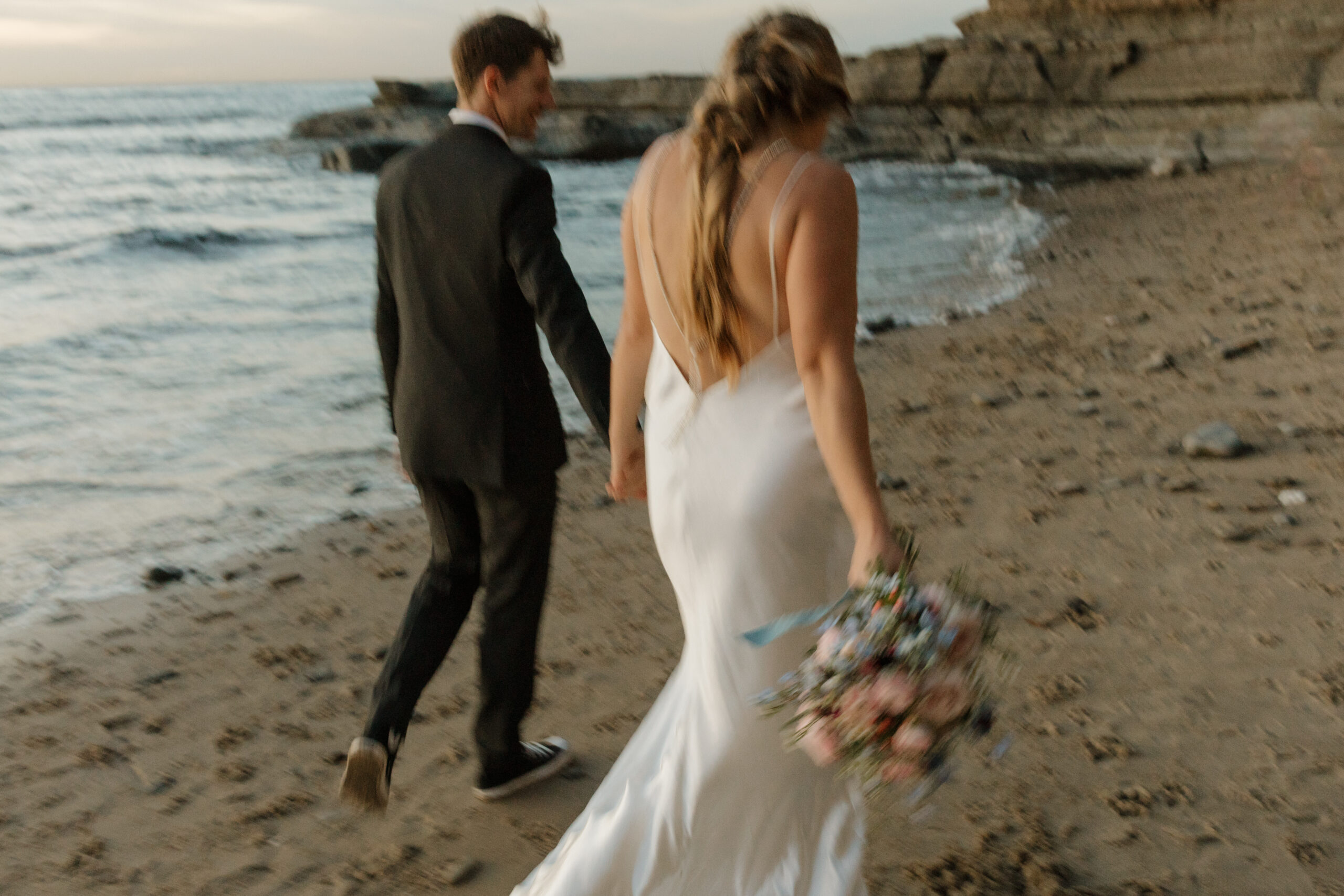 Blurry phot oof couple walking away from the beach