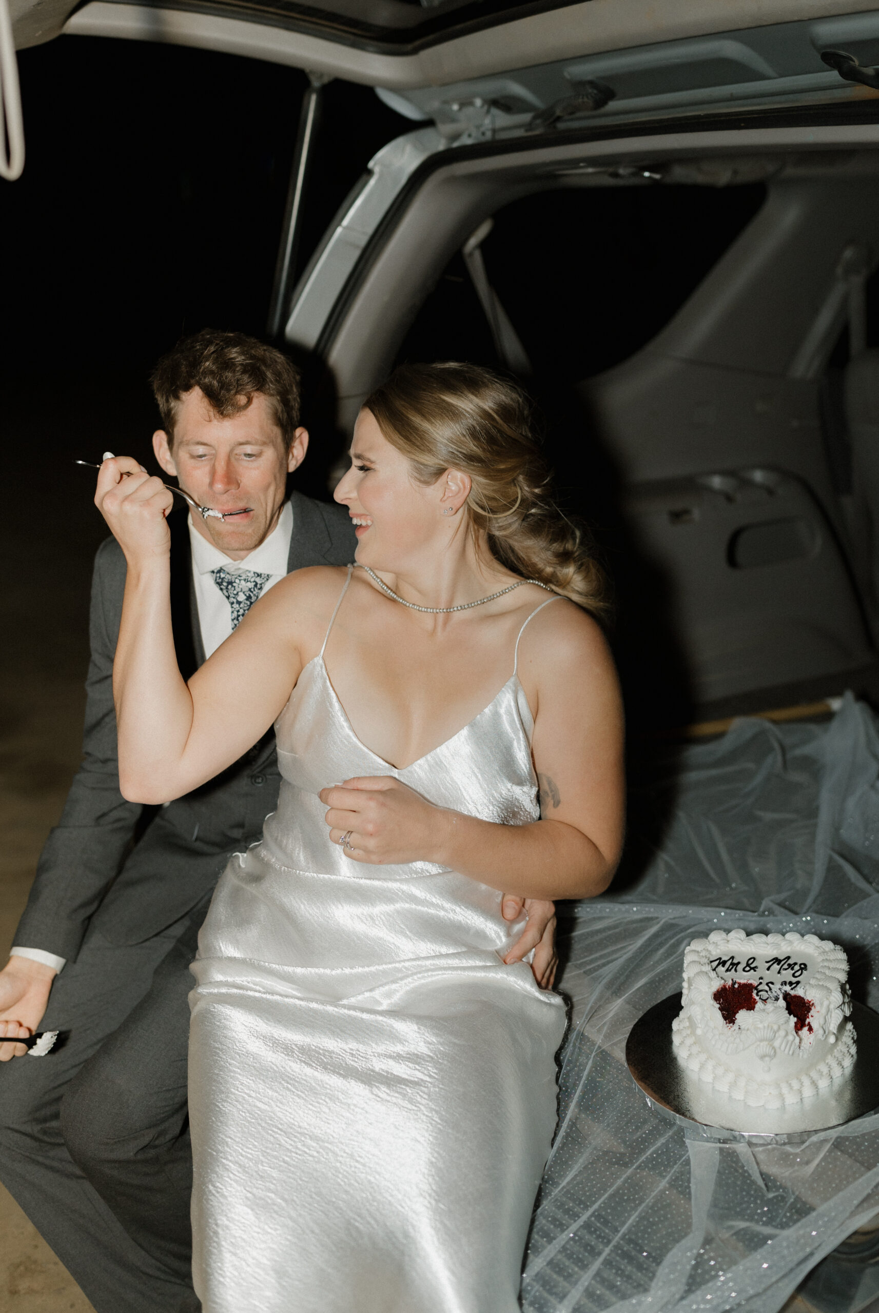 Bride feeding cake to groom