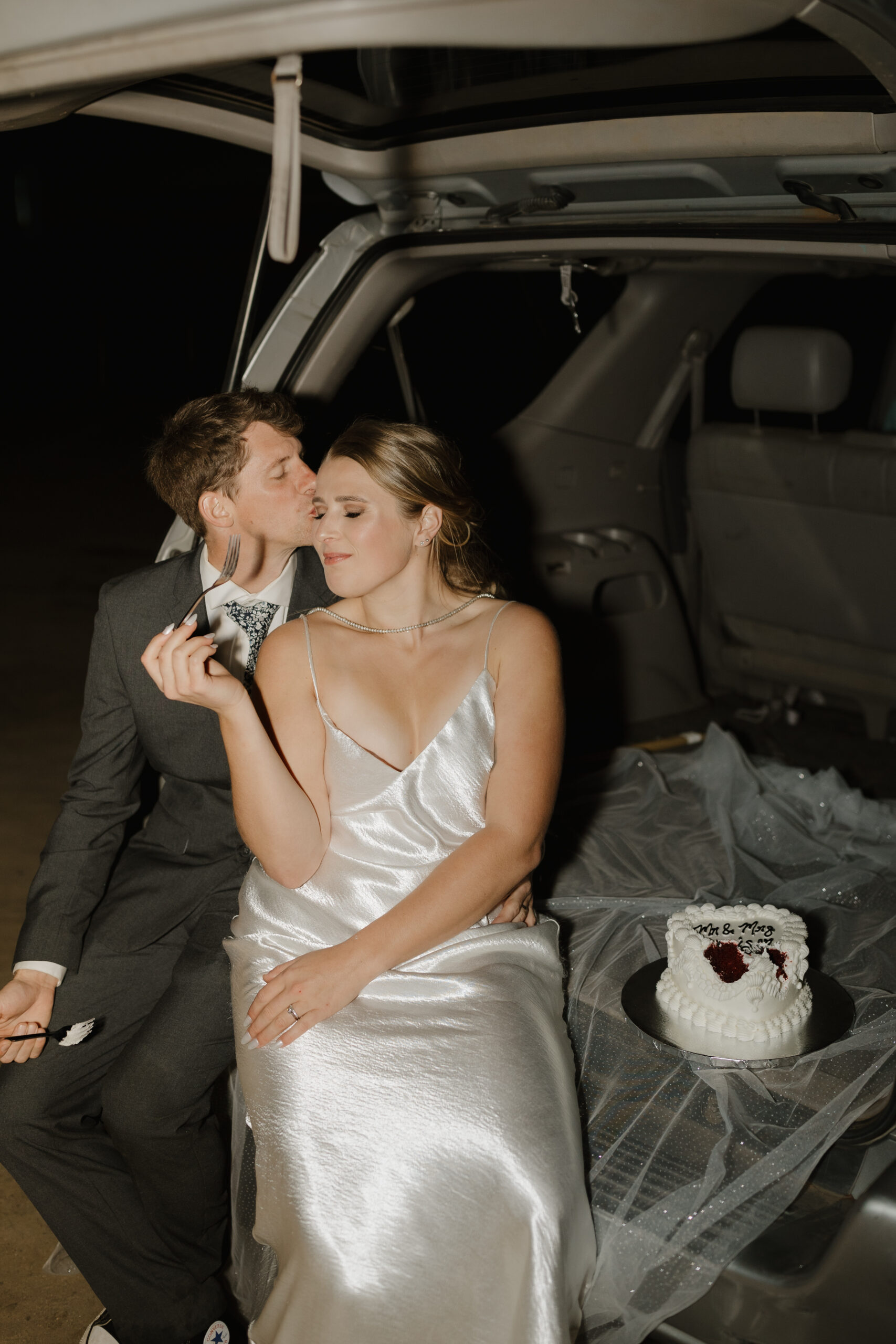 Groom kissing brides temple