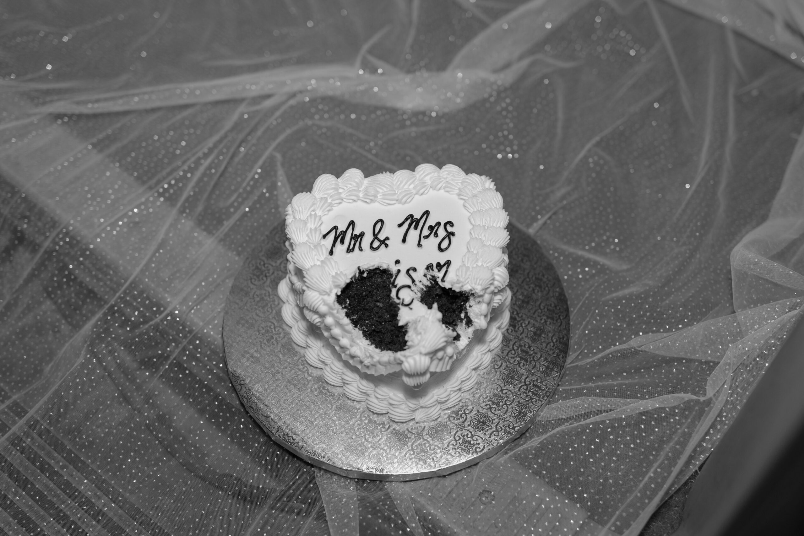 Black and white photo of wedding cake after it's been eaten