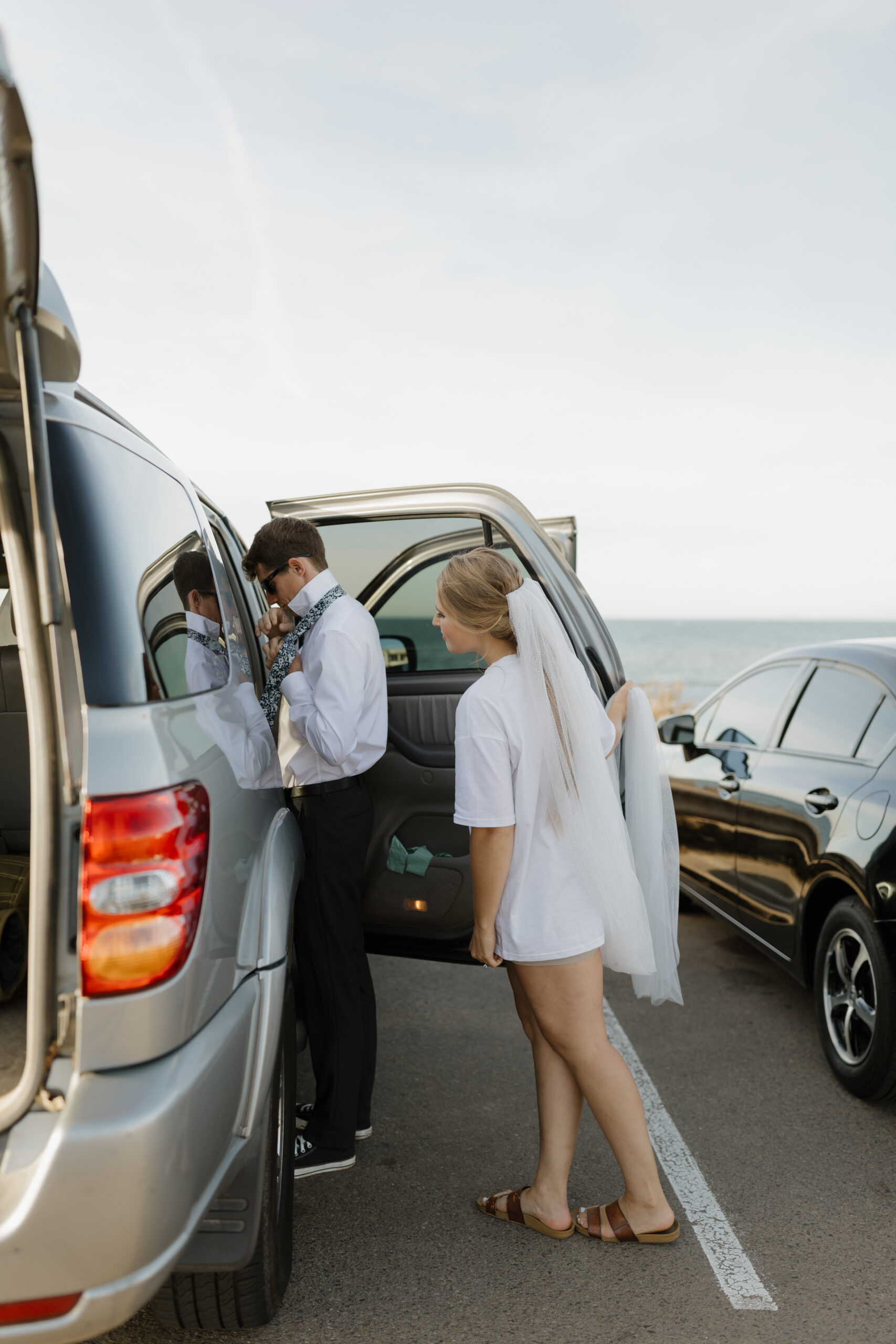 Bride watching groom get ready