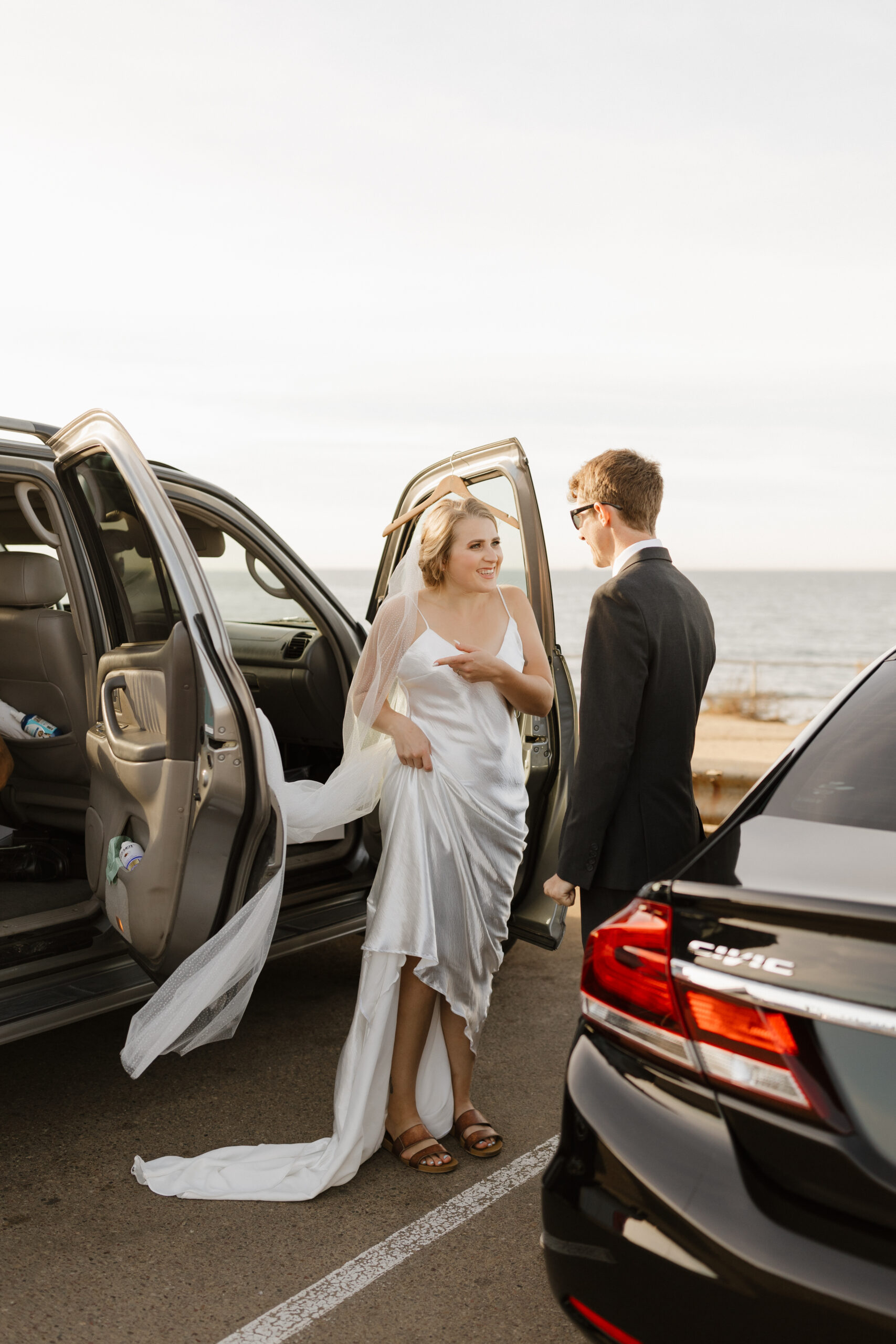 Bride pointing at her veil