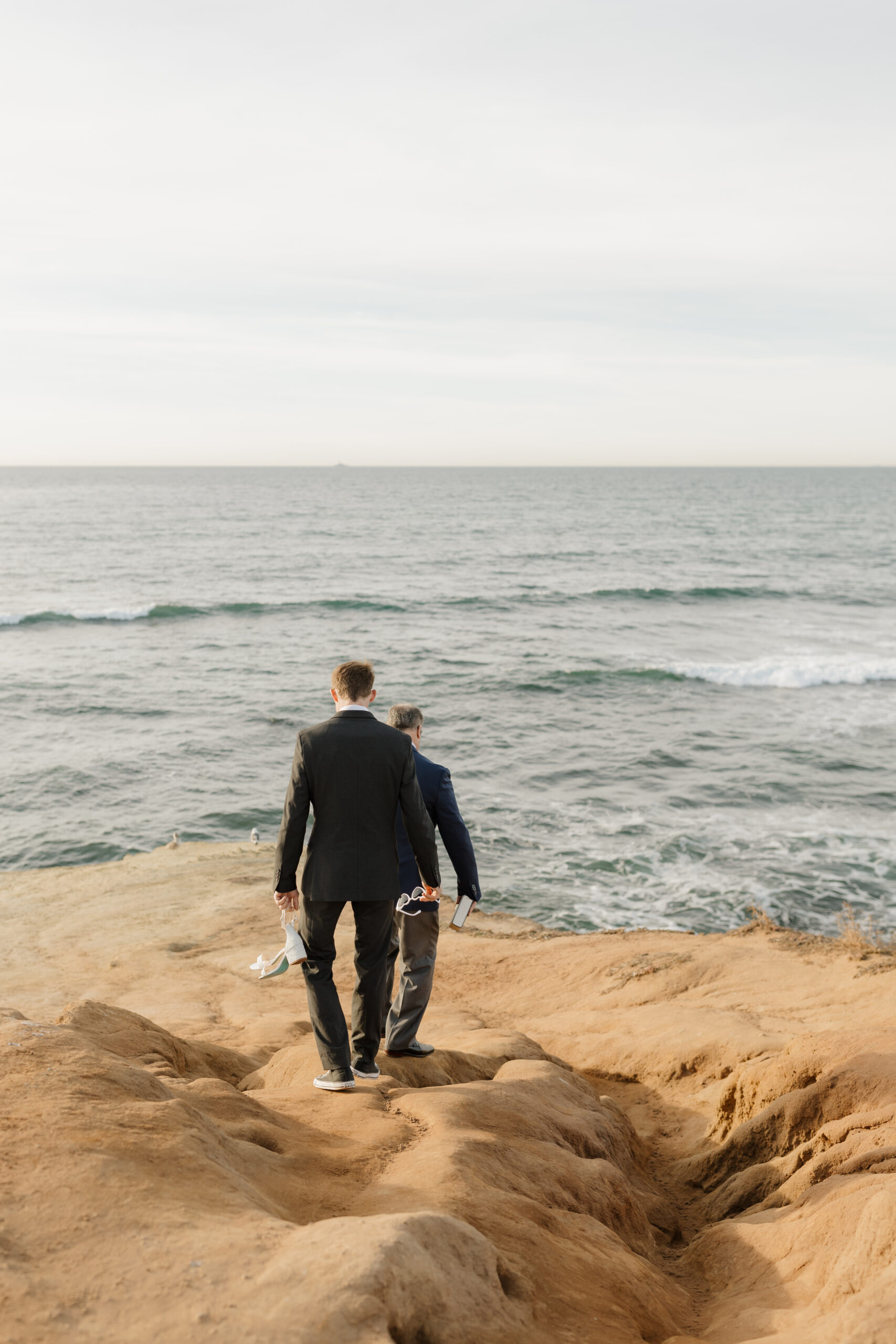 Groom and officiant walking to ceremony site