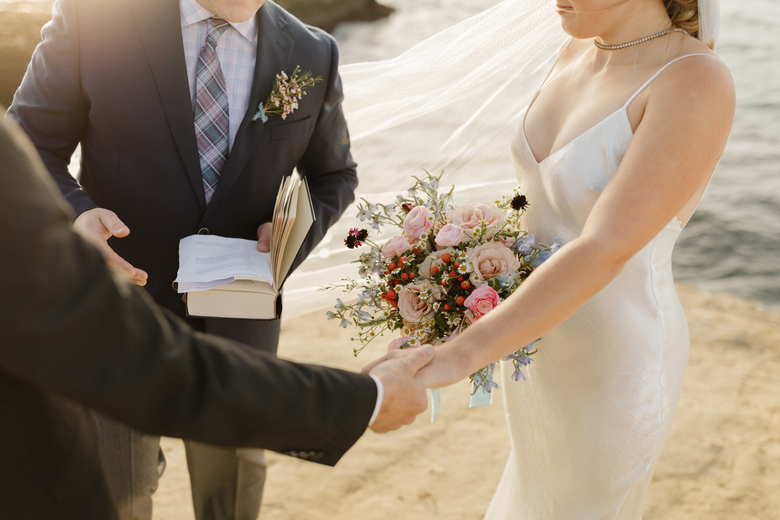 Couple holding hands while getting married