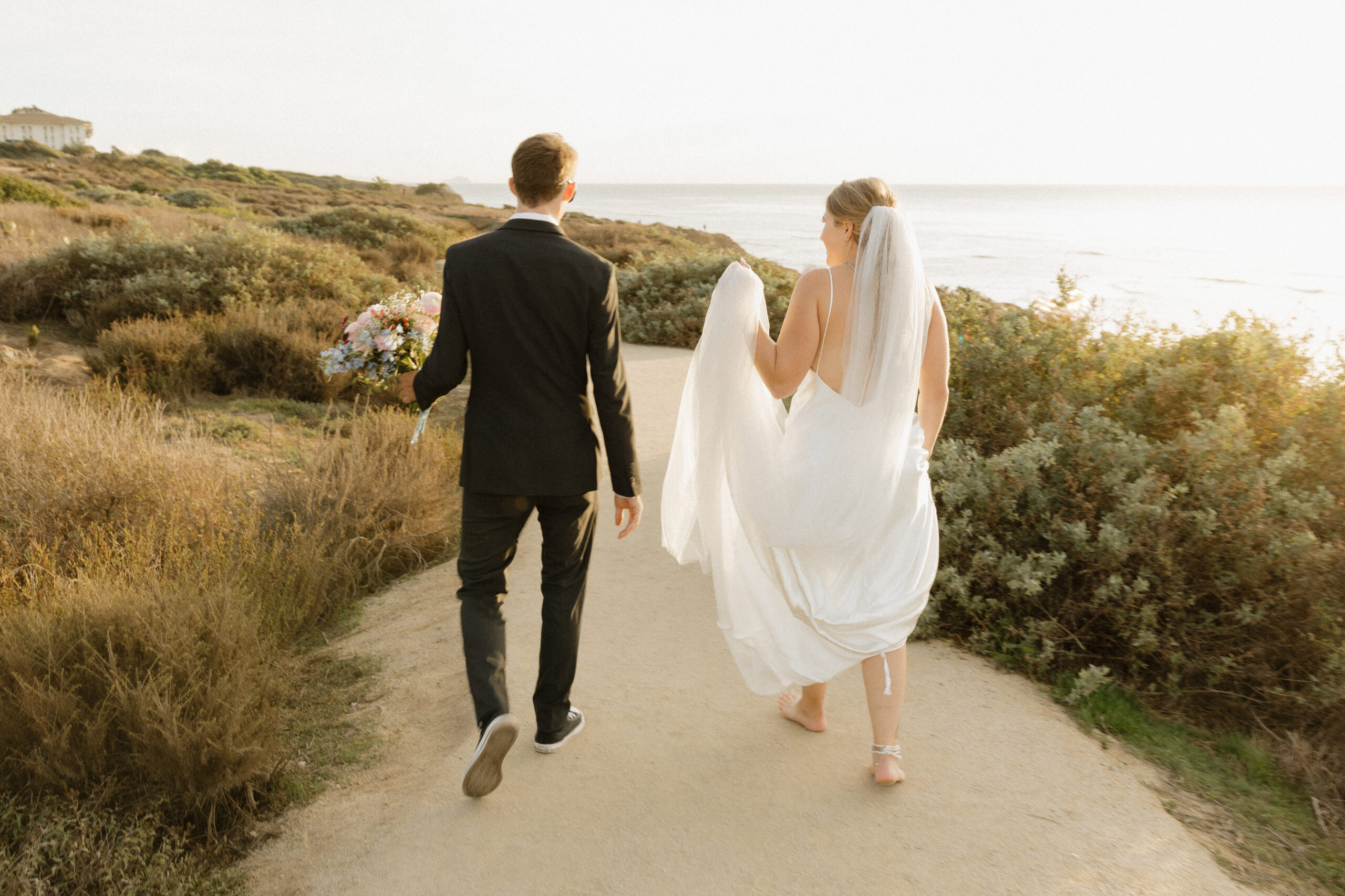 Bride and groom walking away from the camera