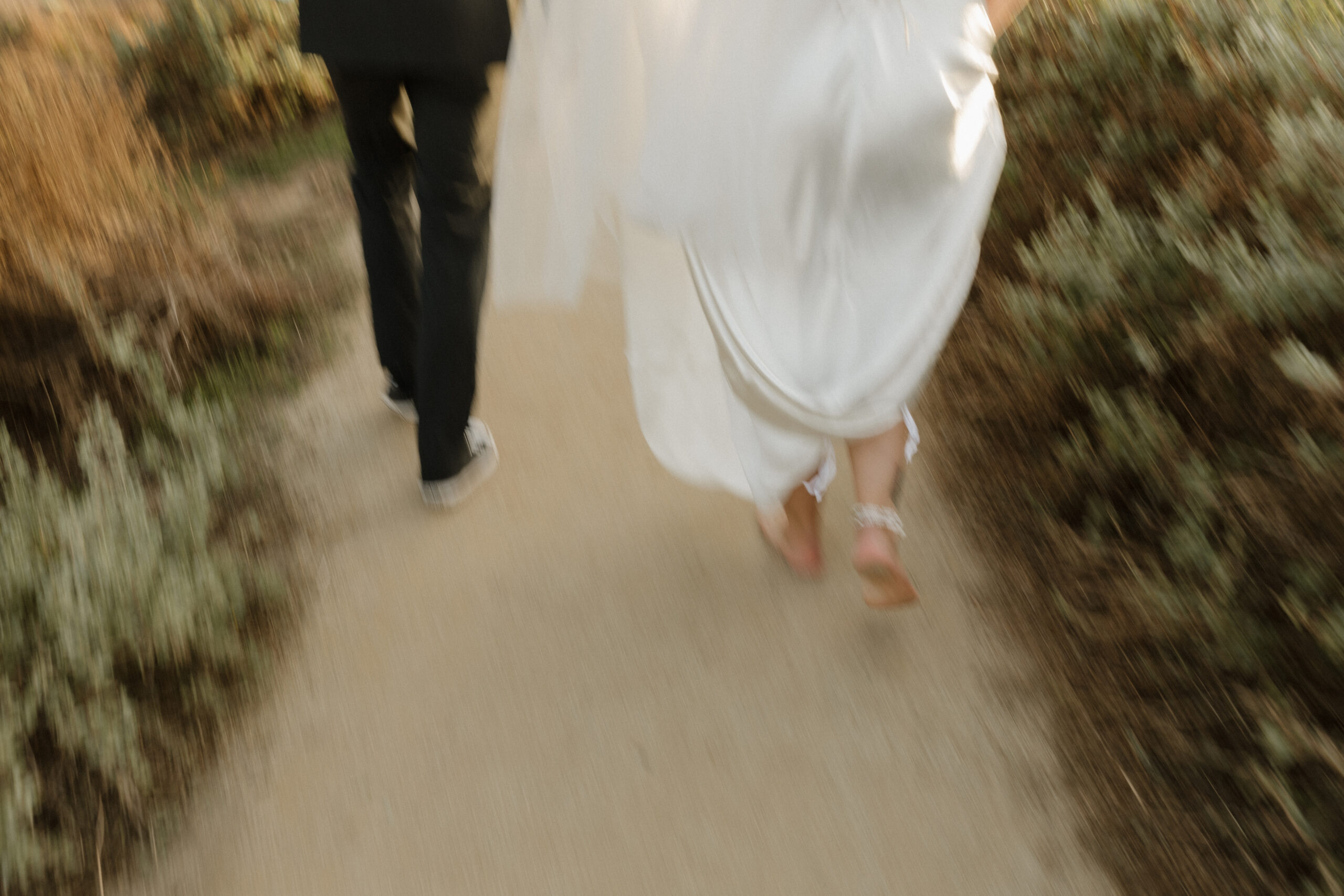 Blurry photo of a bride walking barefoot