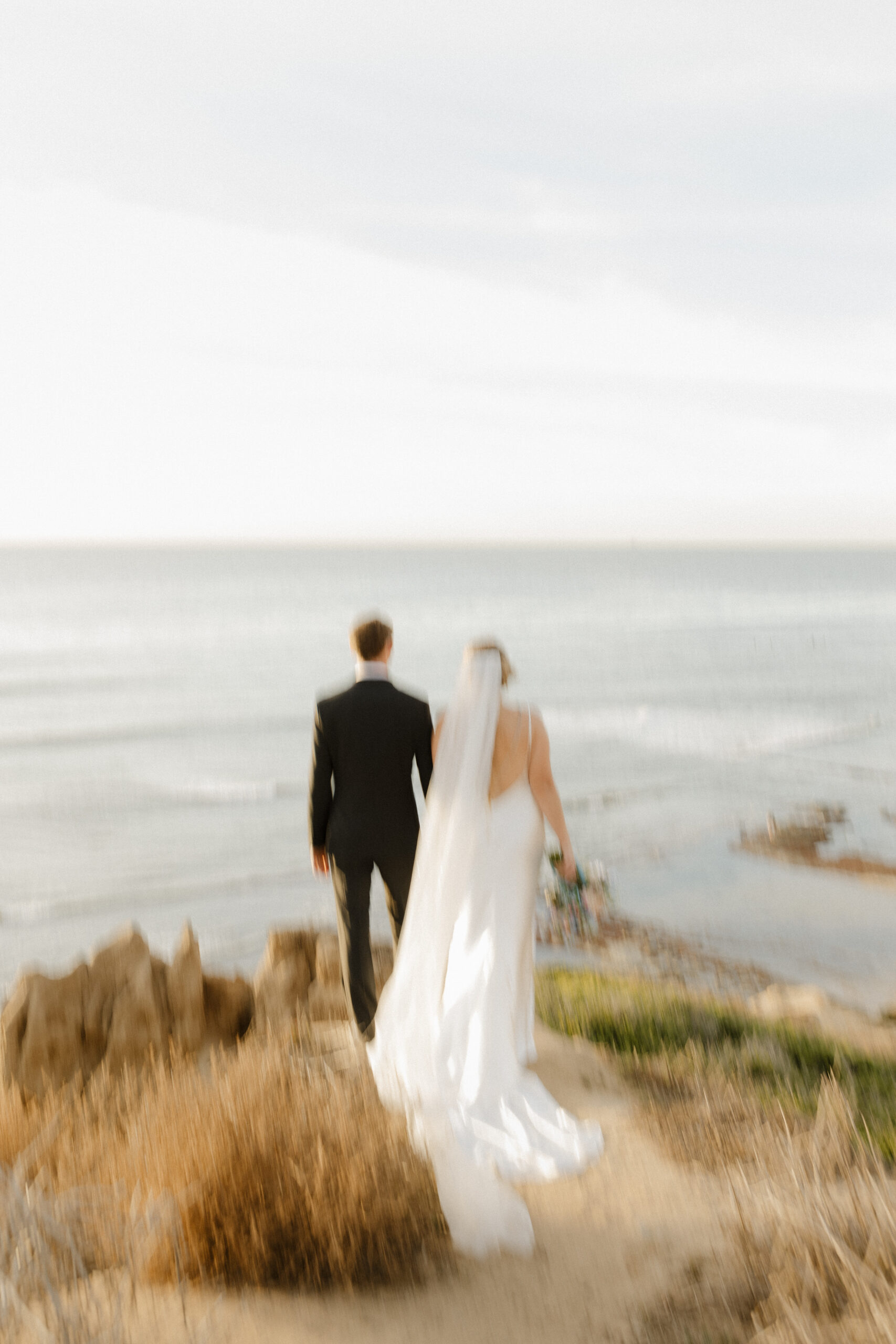 Blurry photo of couple standing cliffside