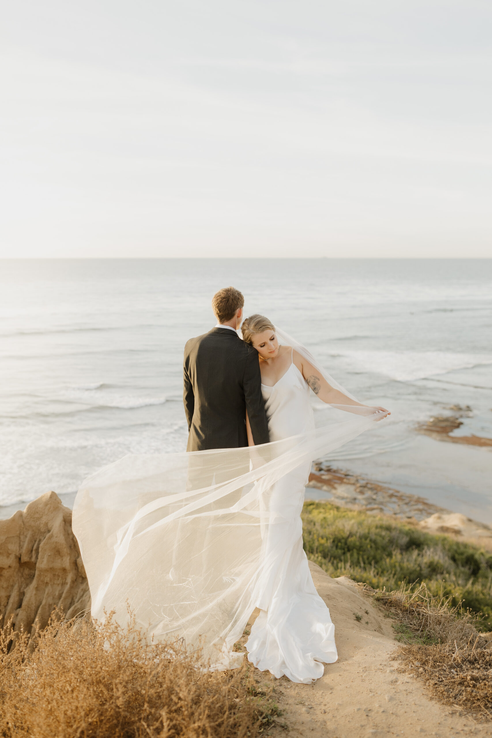 Bride letting her veil blow in the wind