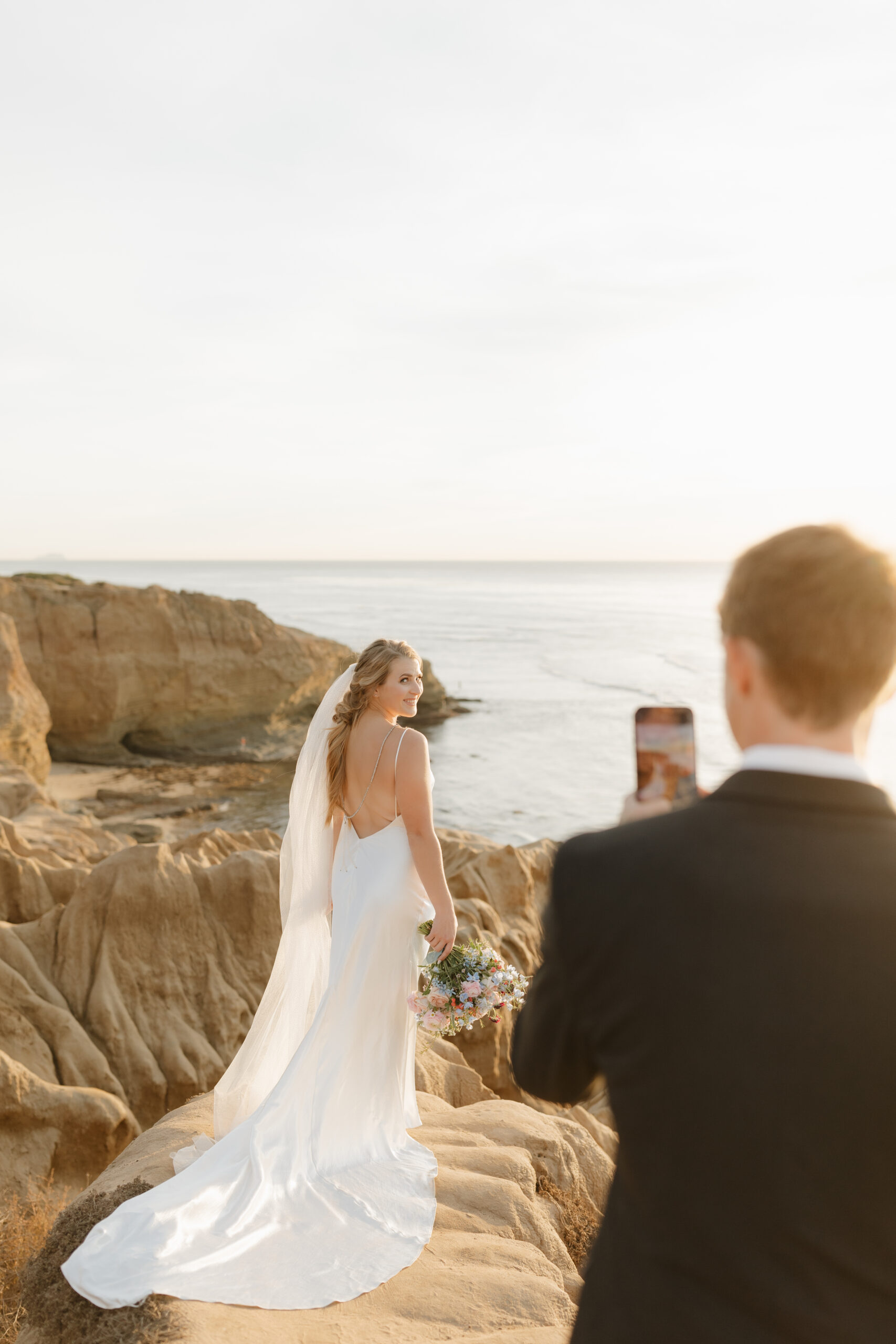 Groom taking a photo of the bride