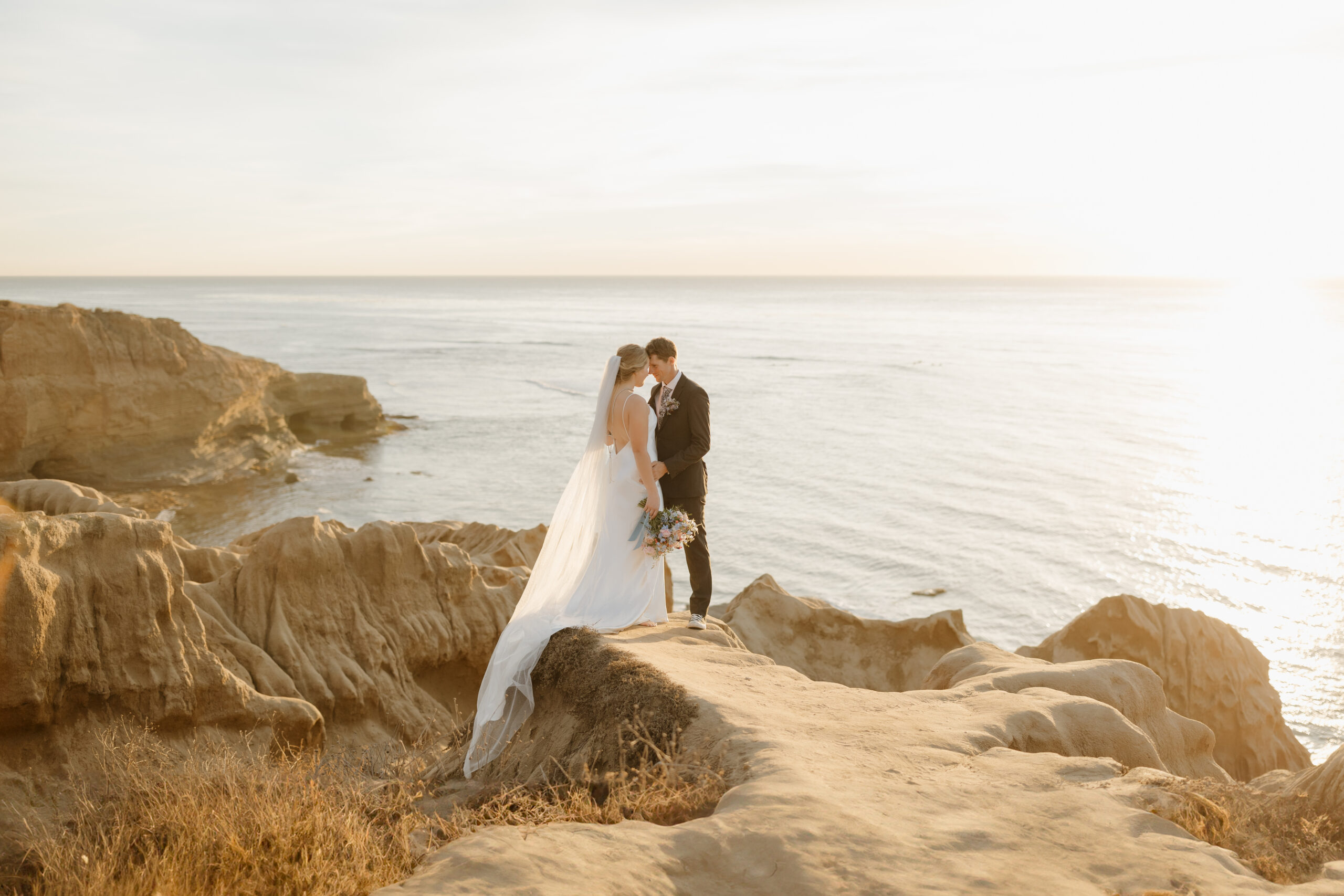 Couple with foreheads touching overlooking the ocean