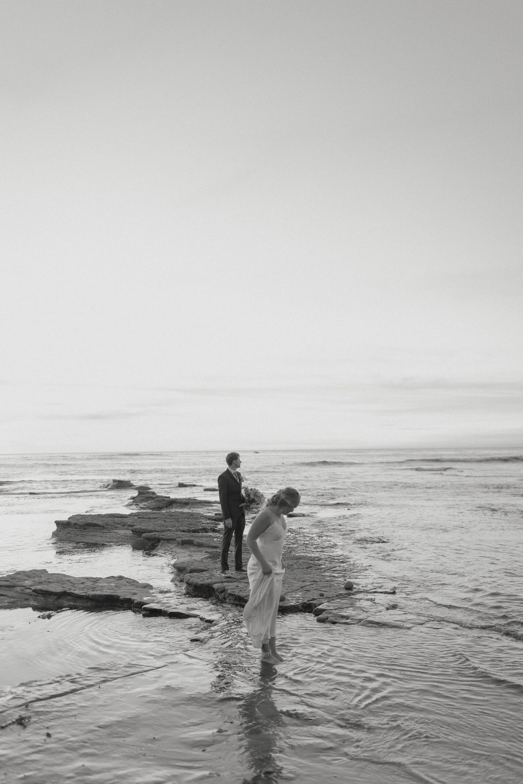 Couple standing with their feet in the water