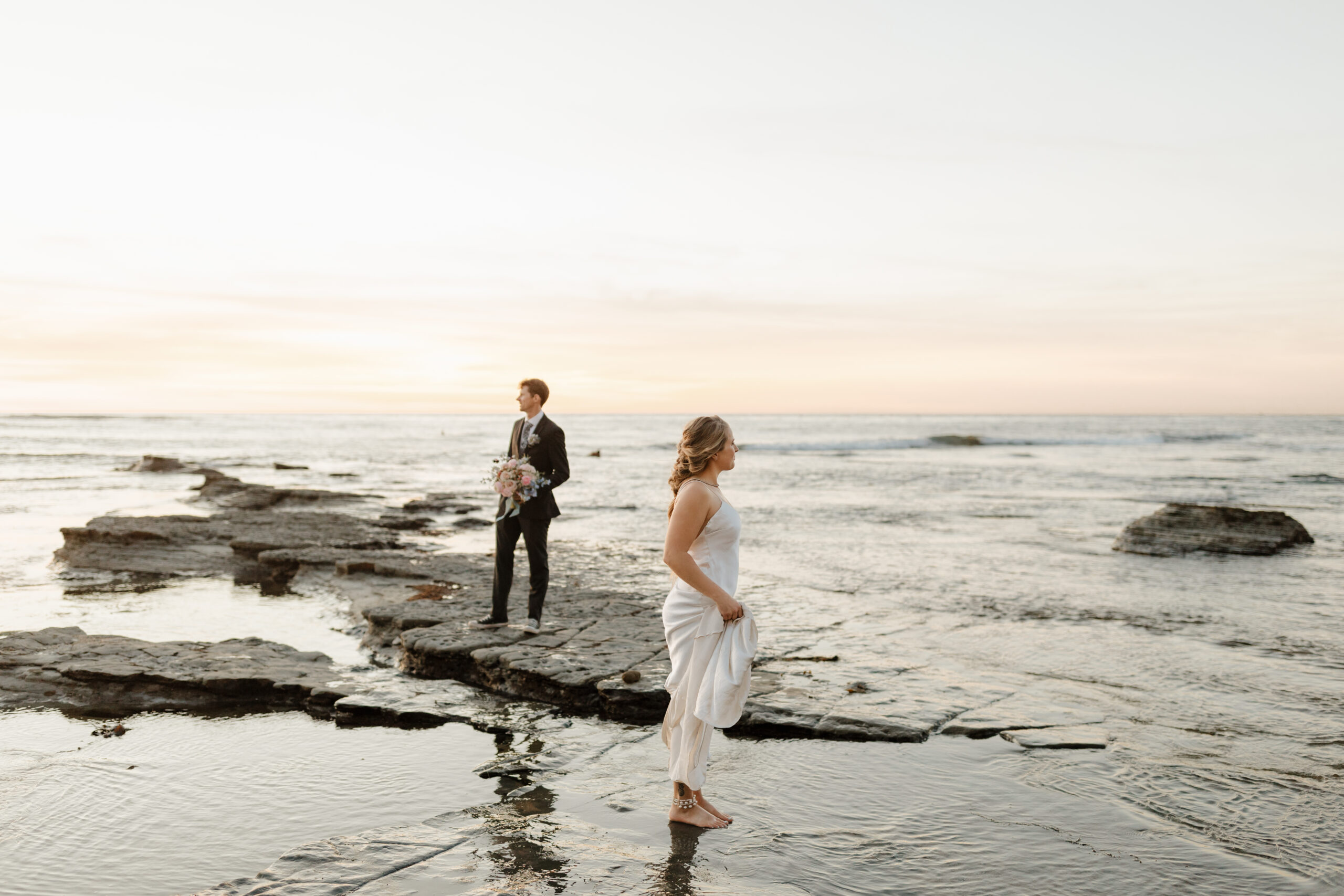 Couple standing with their feet in the water