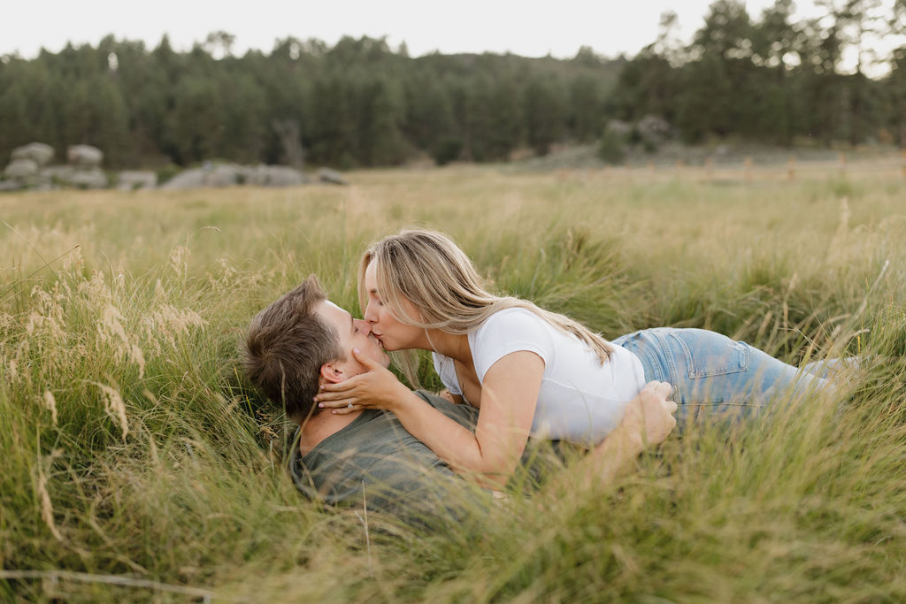 Couple cuddling on the forest floor