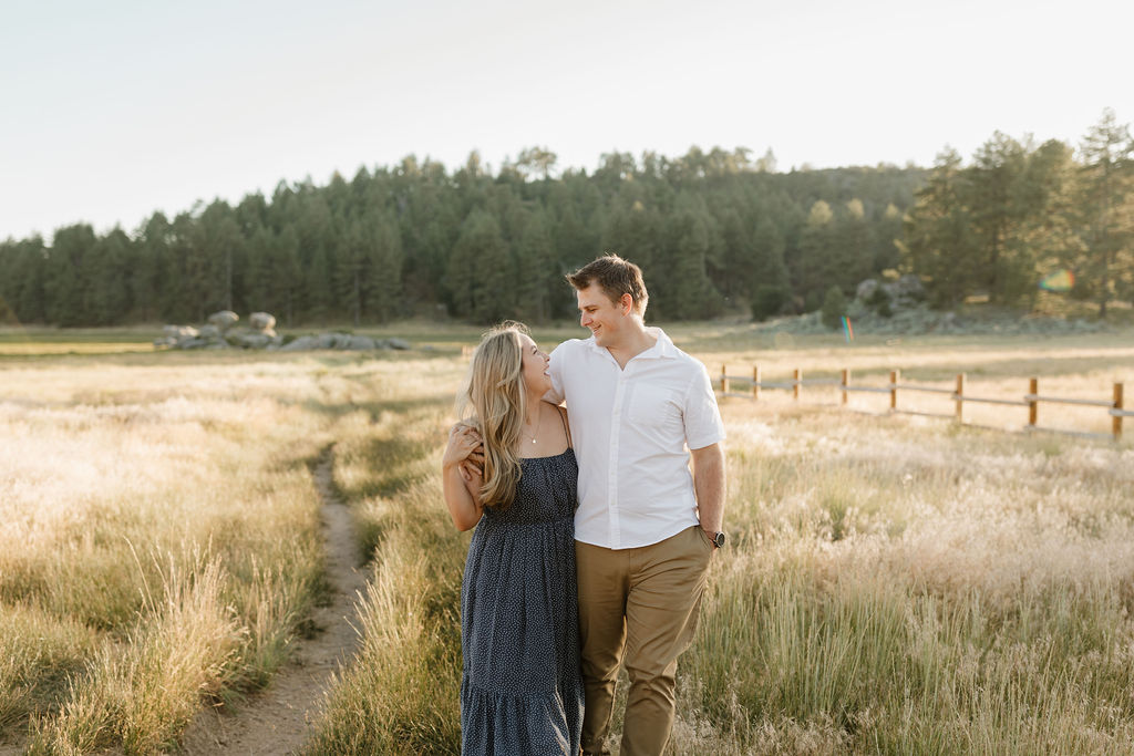 Couple arm in arm walking in a field