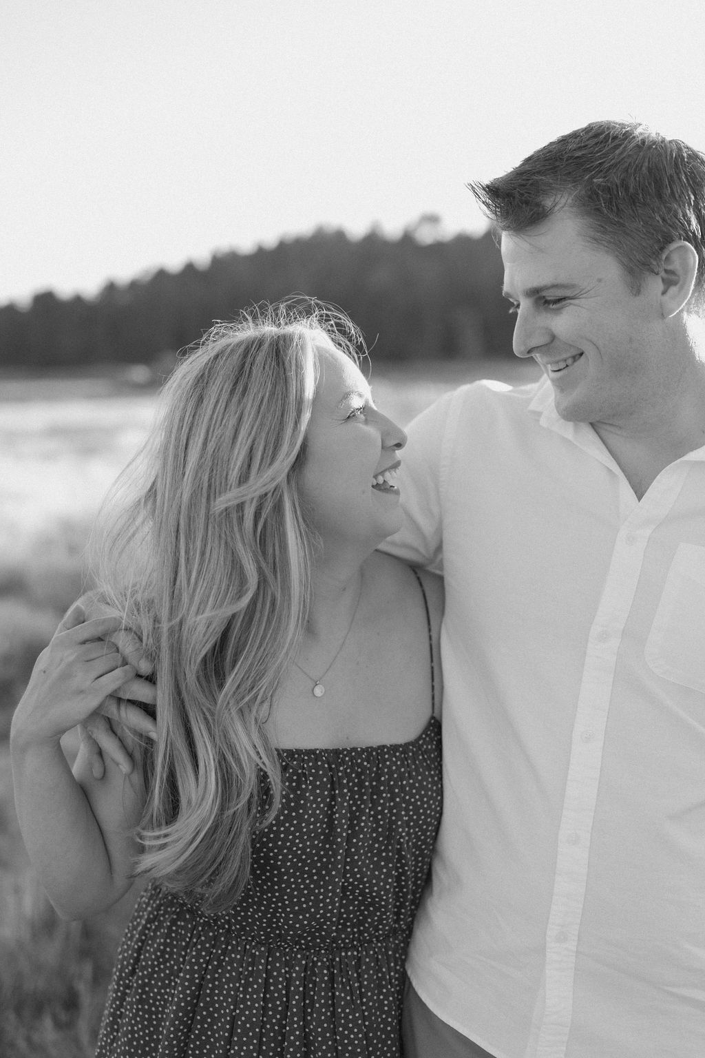 Couple arm in arm walking in a field