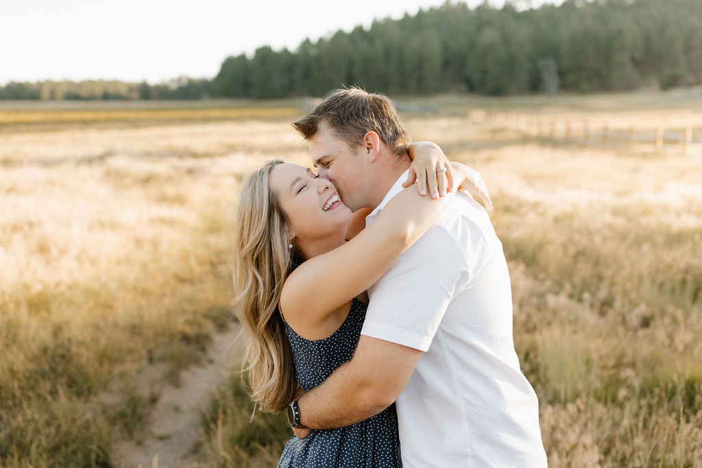 Man kissing woman on temple