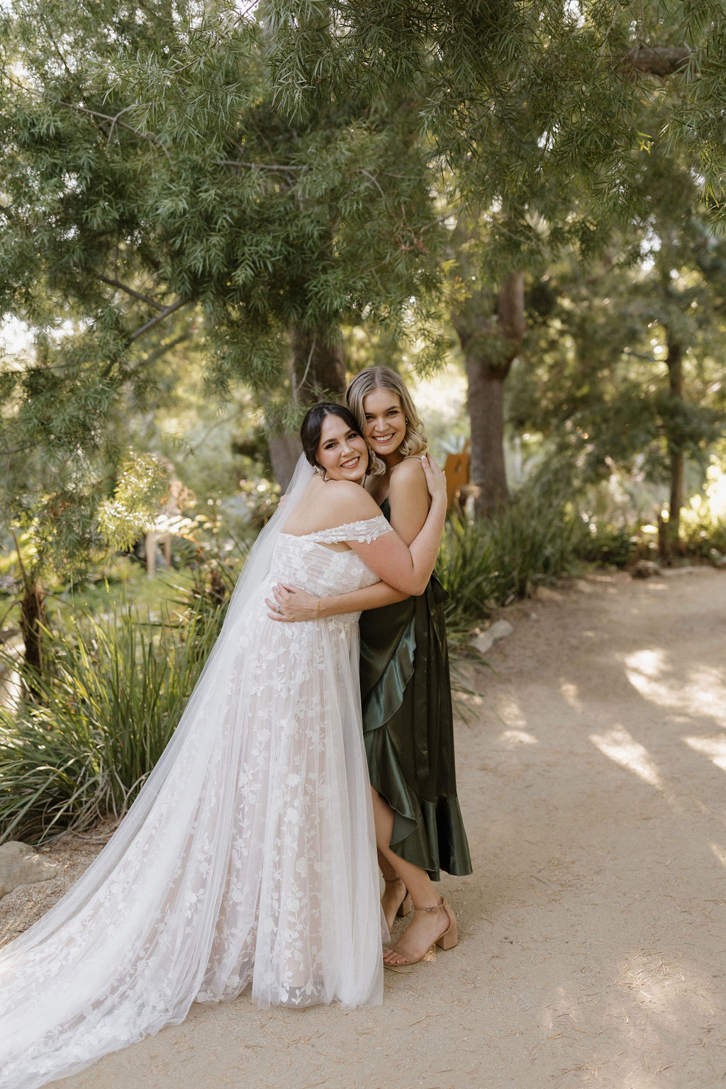 Bride hugging her bridesmaid 