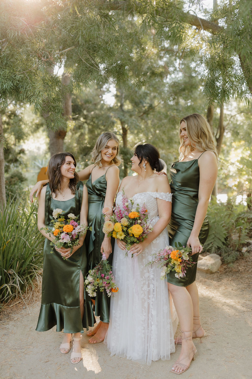 Bride with her bridesmaids and the sun in the background