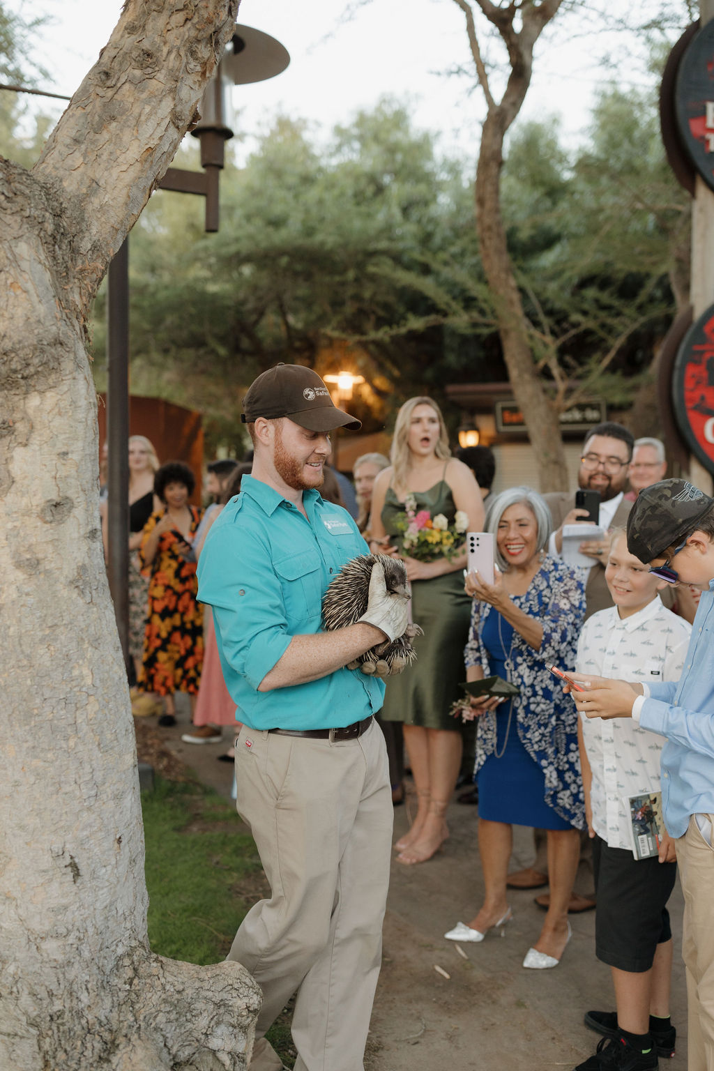 A San Diego Safari Park zookeeper holding an animal for guests to see. 