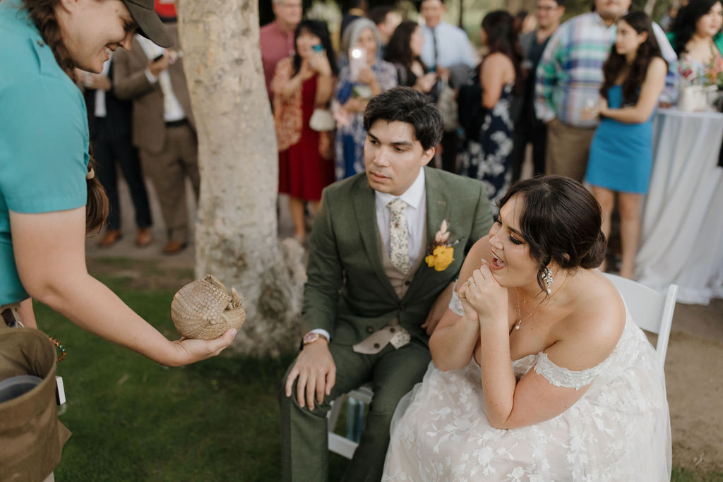 Bride and groom seeing an animal up close and personal at the San Diego Zoo Safari Park. 