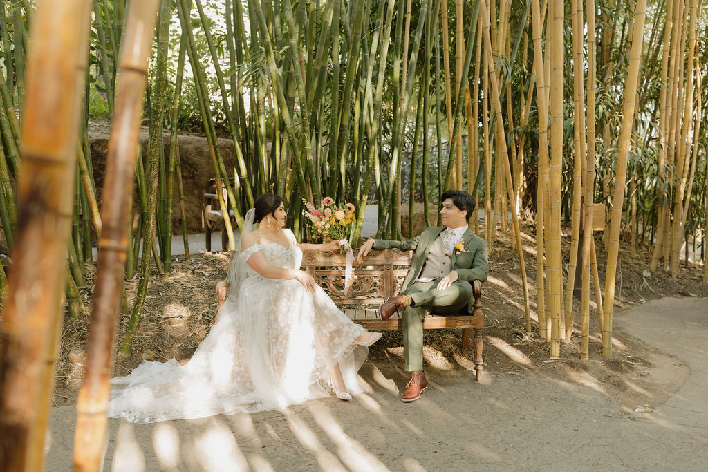 Couple sitting on a bench in the bamboo forest. 