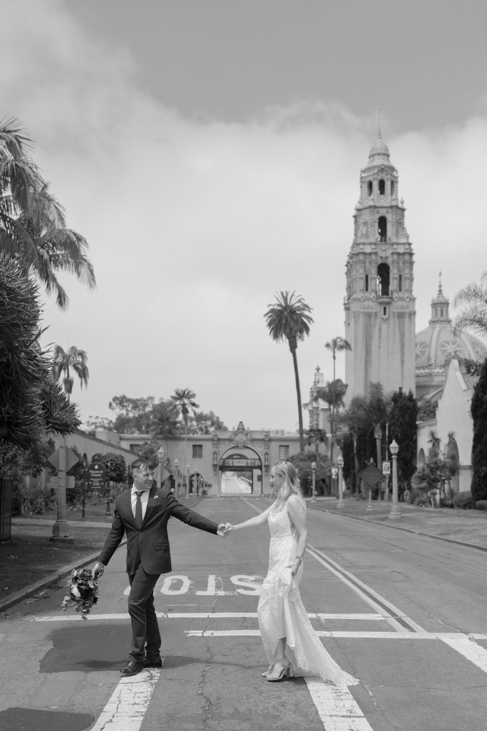 Couple crossing the street at Balboa Park in elopement attire