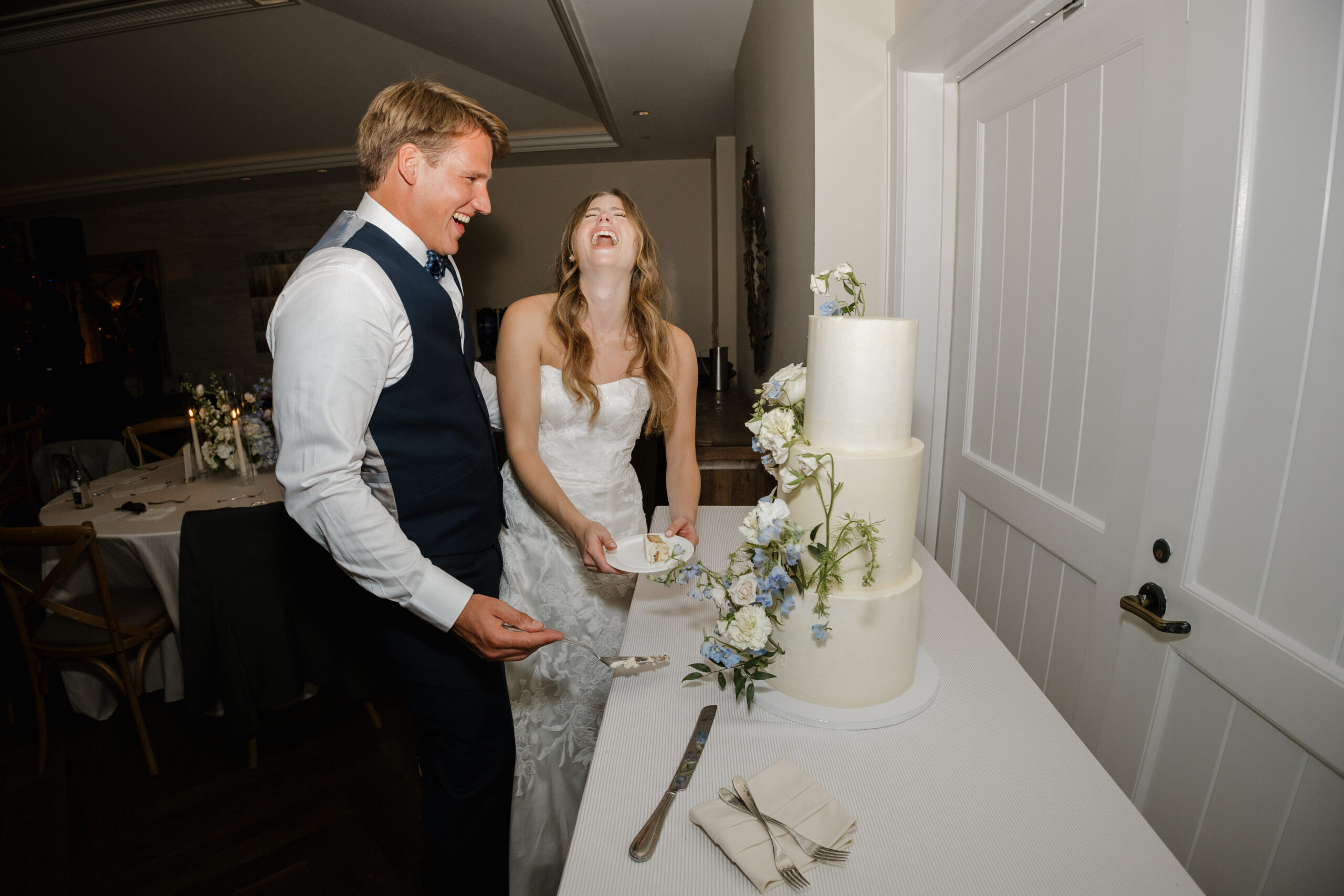 Wedding Couple laughing after cutting their cake