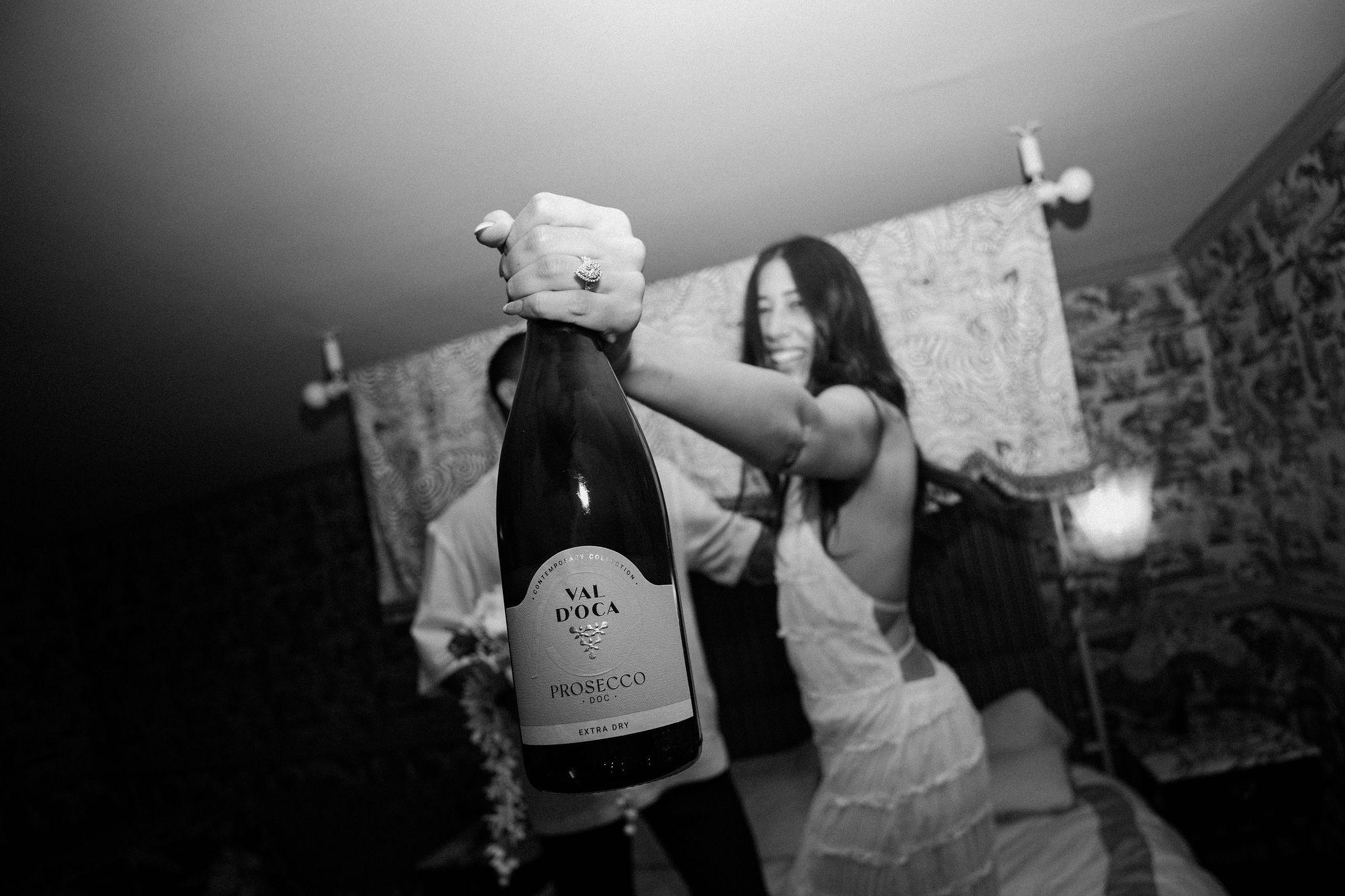 Elopement couple celebrating their marriage at The Lafayette hotel with a bottle of champagne 